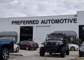 Preferred Automotive building with several vehicles parked outside.