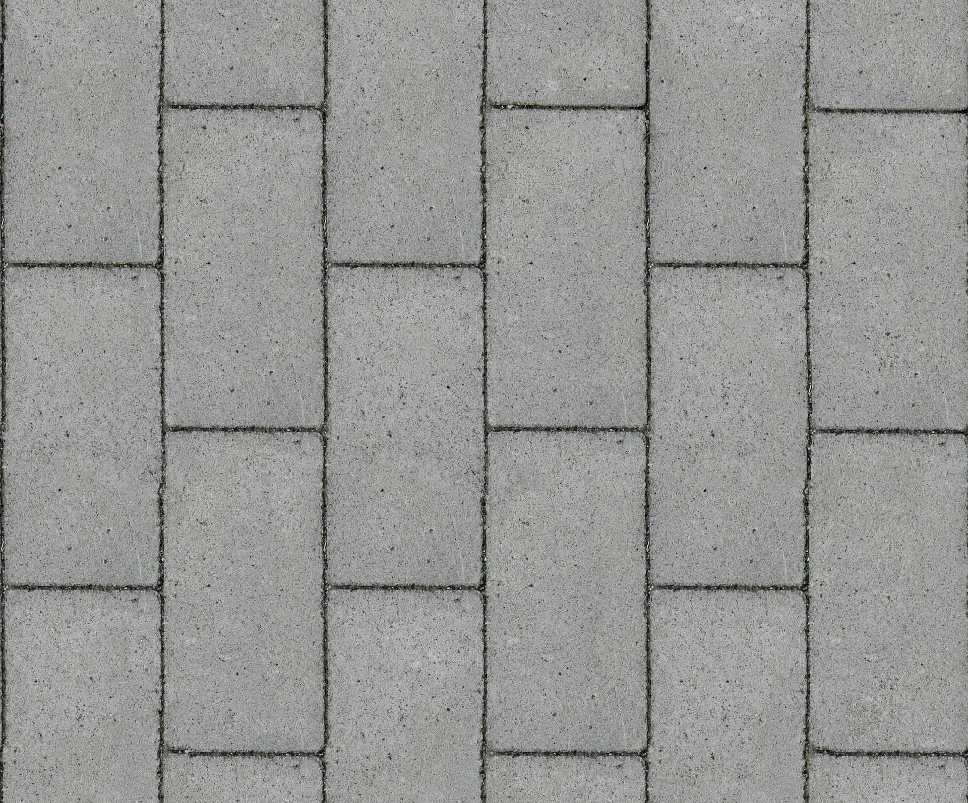 A seamless texture of gray bricks on a sidewalk