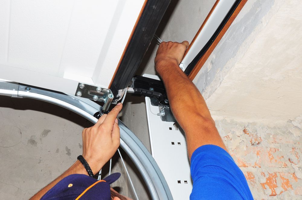 Professional Worker Repairing Garage Door Sliders