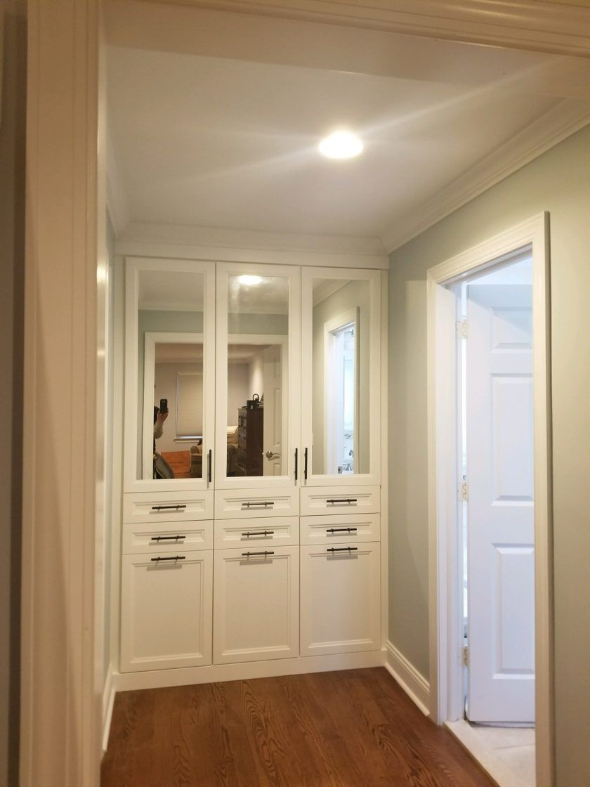 This Madison, NJ built-in includes hampers, drawers and lots of mirrors.