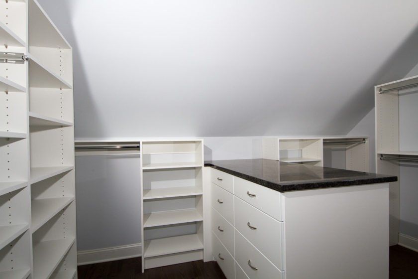 Maximized drawer space with a marble topped peninsula in this Little Falls, NJ closet system