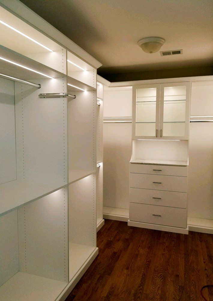 This beautiful closet has marble tops, glass shelves and is all lit up with LED lighting. Crown and base mold complete the look.