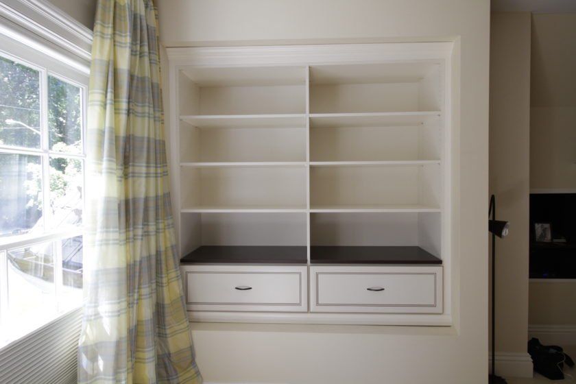 This Englewood, NJ client want to make use of a little alcove in the master bedroom for storage of books and other items. This antique white built-in also comes with 2 large drawers.