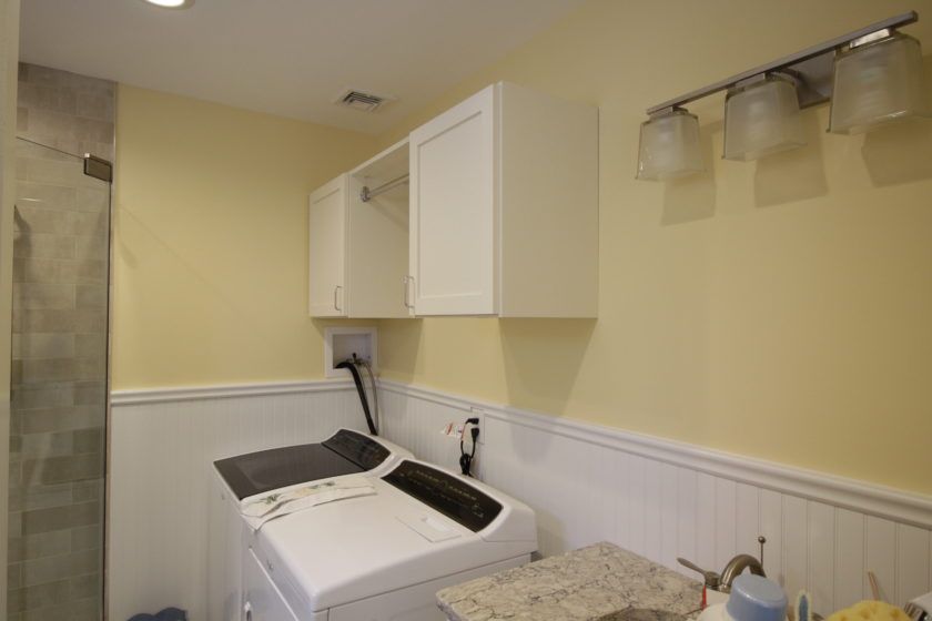 This laundry room needed extra storage and hanging space while still looking organized. Everything behind doors keeps it neat and tidy looking.