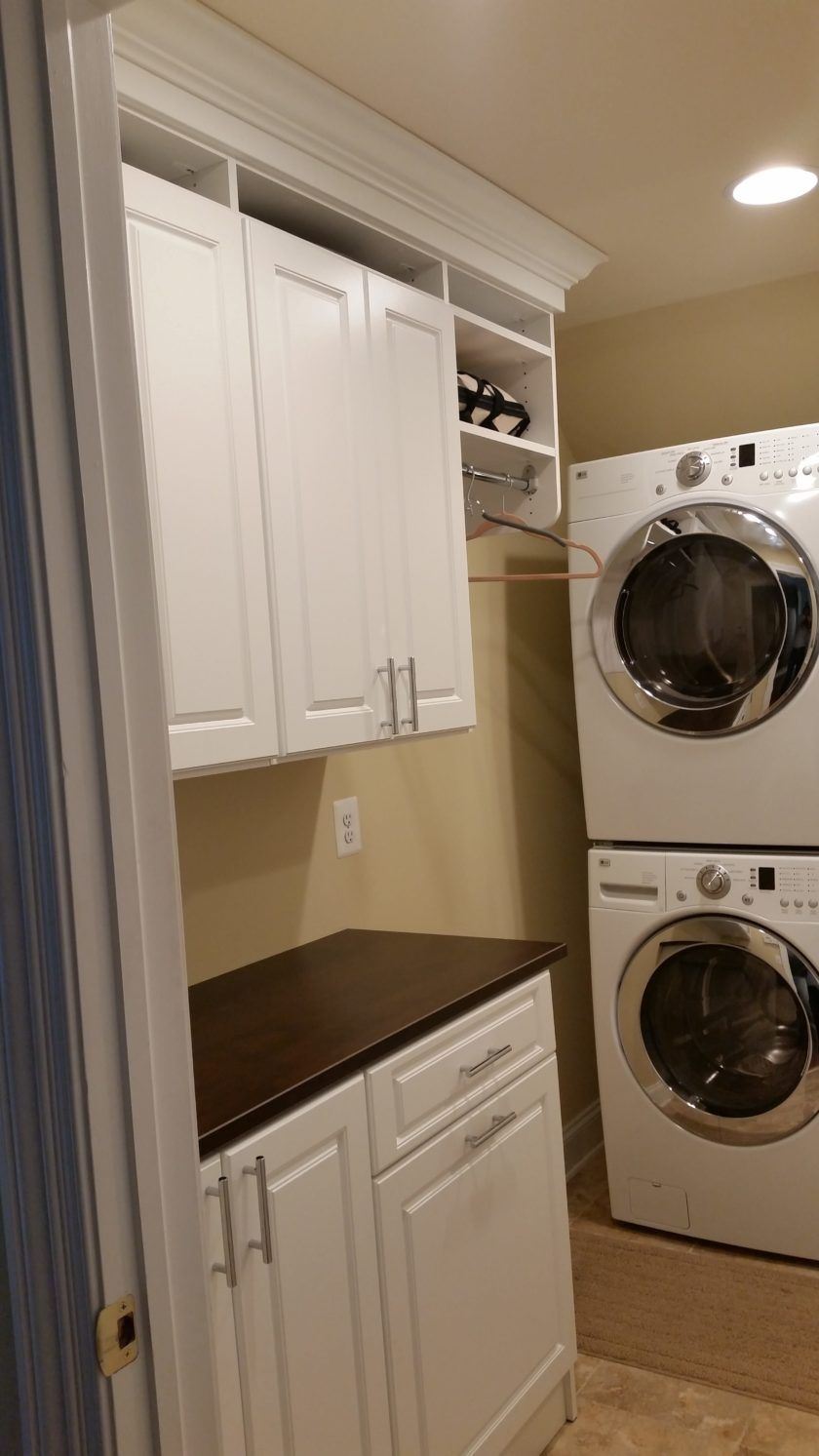 This updated laundry room added counter space for folding with drawers and doors to hide the cleaning supplies. Westfield, NJ