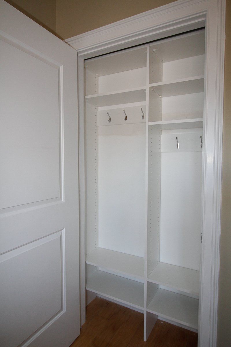 This shallow reach-in closet in Jersey City, NJ could not utilize normal hang space, so we made it into a mini mudroom, complete with shelves, hooks for coats, and bead board backing.