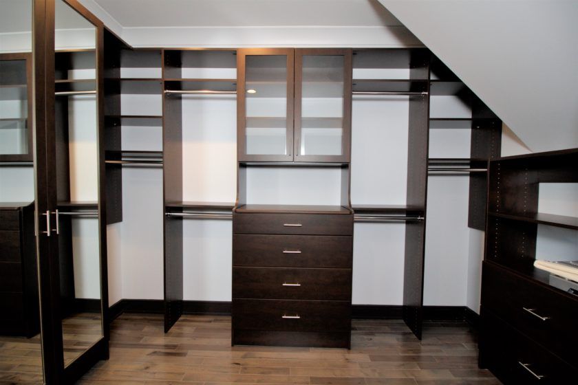 Maximum space utilization in this angled ceiling master closet system. Chocolate Pear color, mirrored door shoe tower, and double hutch - Westfield, NJ
