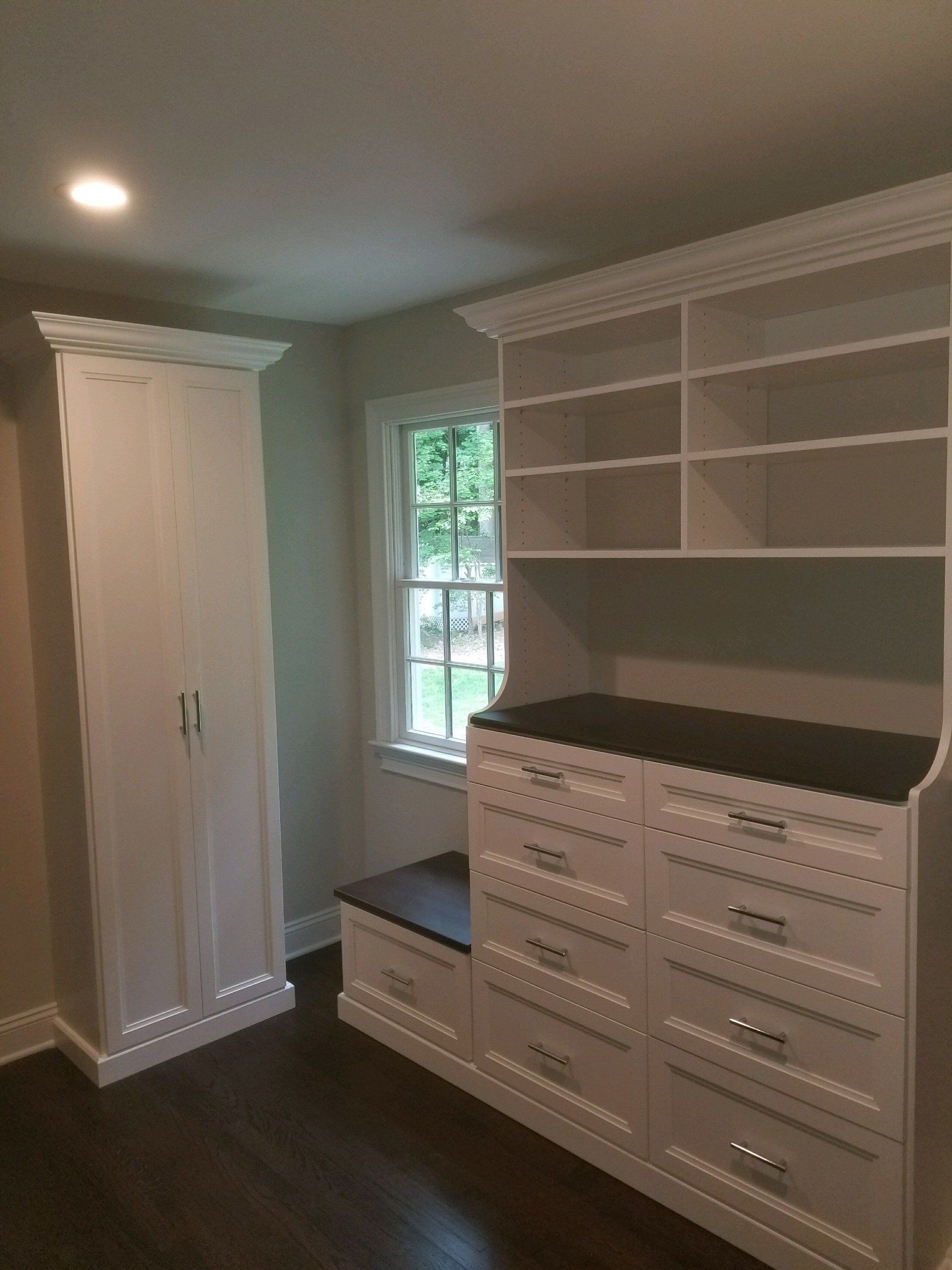 Walk in closet system with bench for putting shoes on along with a built-in linen closet! Chatham, NJ