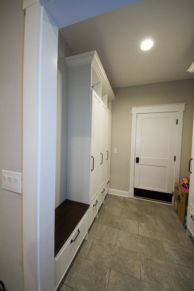 This locker style mudroom in Cranford, NJ has enclosed hanging and storage for the entire family.