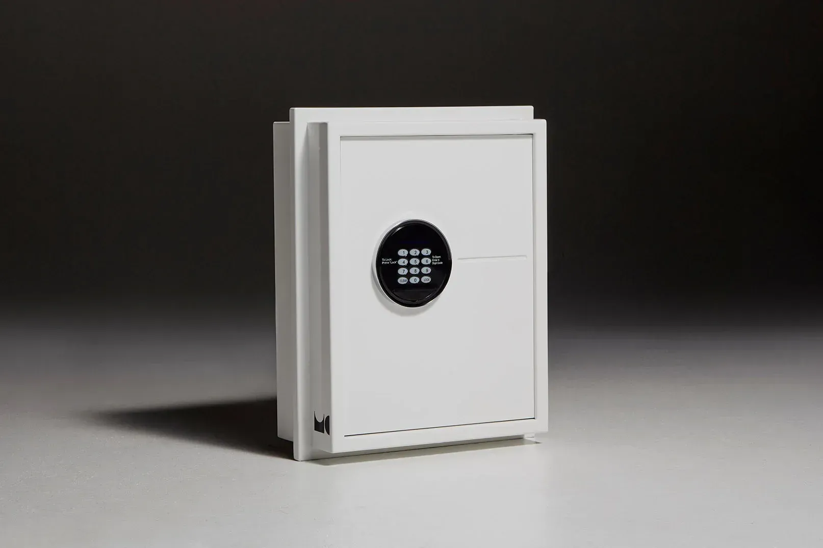 A white safe with a digital lock is sitting on a table.