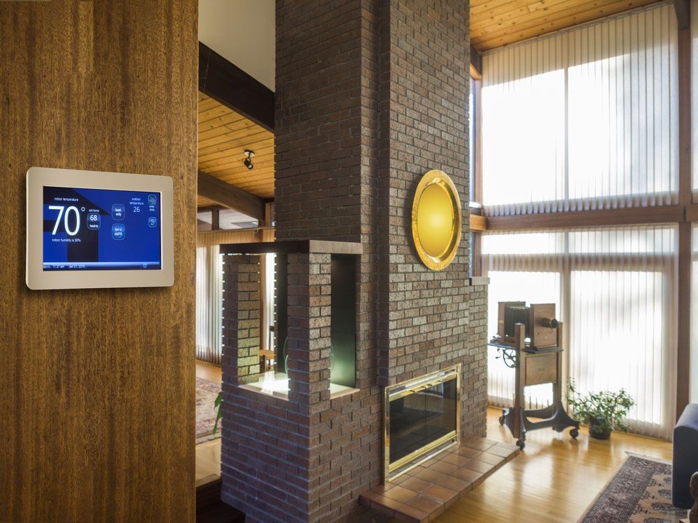 A Living Room With A Fireplace And A Thermostat — RAFFBRO Electrical Solar & Air Conditioning In Wodonga, VIC