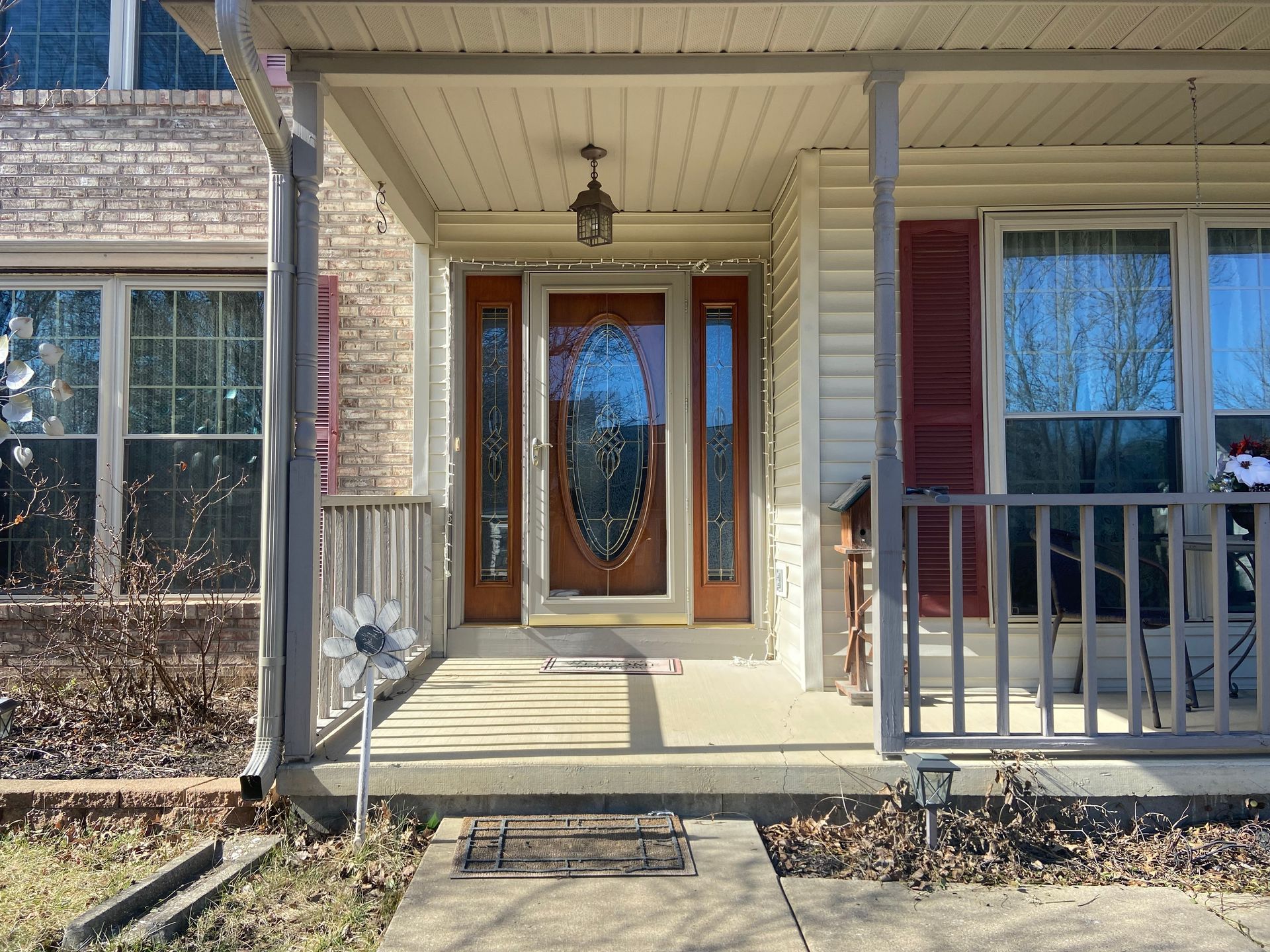 The front of a house with a porch and a wooden door