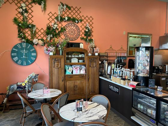 A restaurant with tables and chairs and a clock on the wall.
