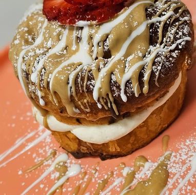 A close up of a dessert with a strawberry on top