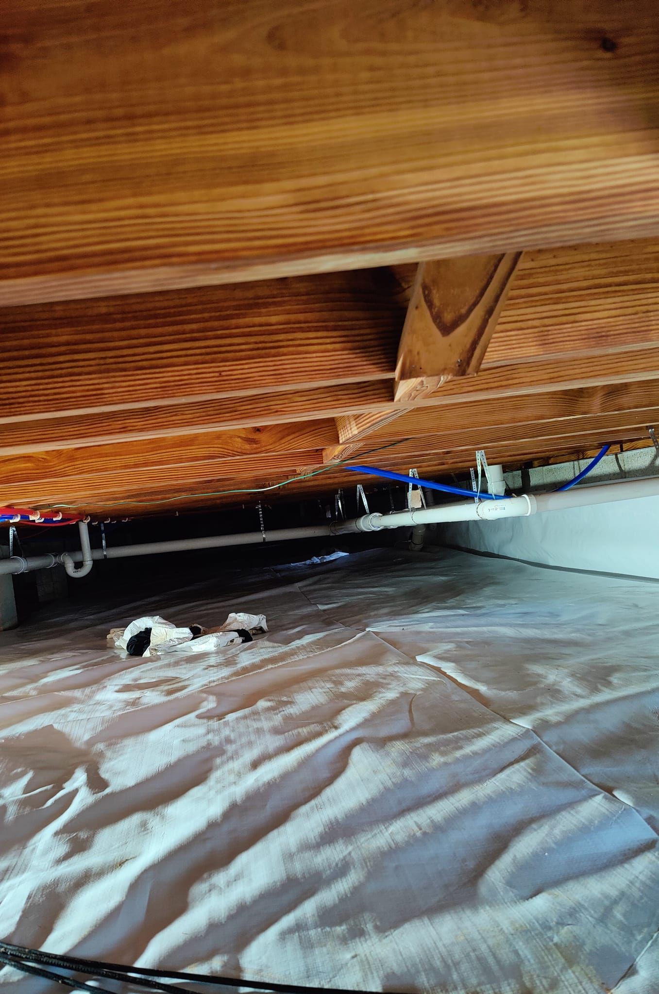 A wooden floor with a lot of wires coming out of it.