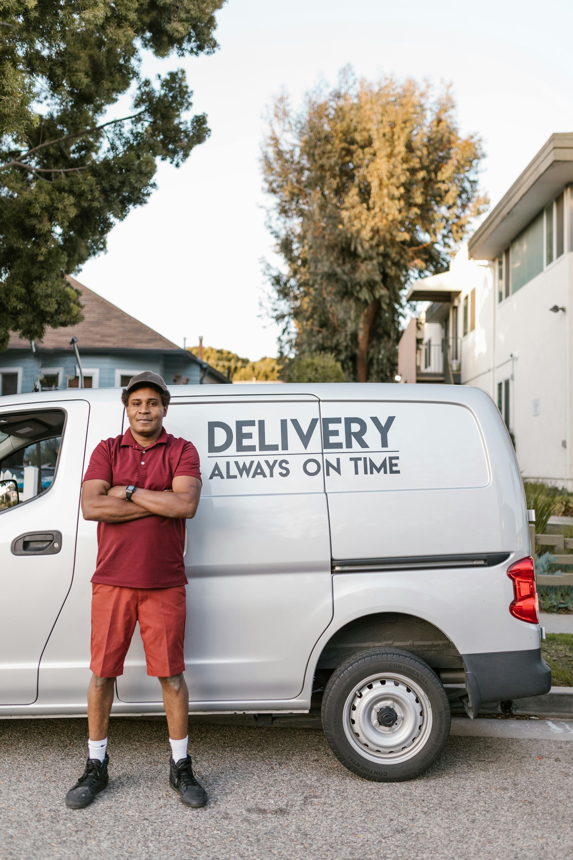 A man is loading boxes into the back of a van.