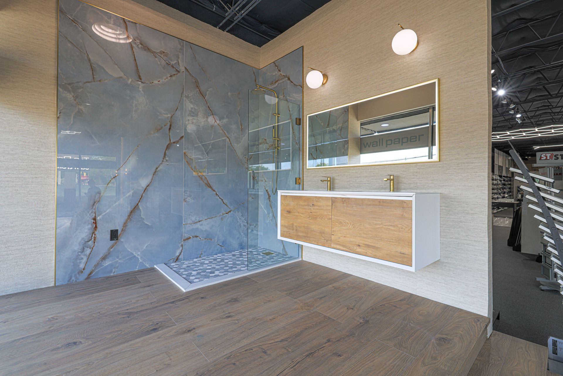 A bathroom with a sink , mirror and walk in shower.