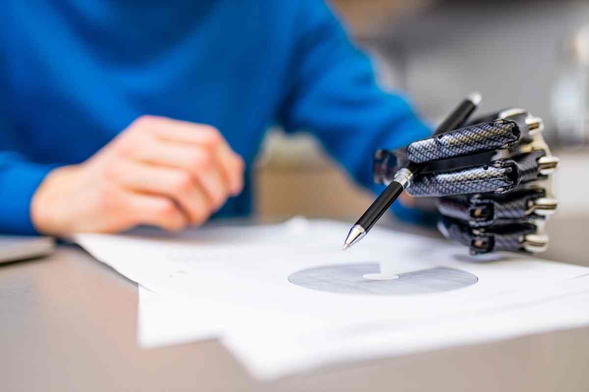 Man with prosthetic hand holding a pen at Durrett’s Orthotics & Prosthetics near Edgewood, KY, and Lawrenceburg, IN