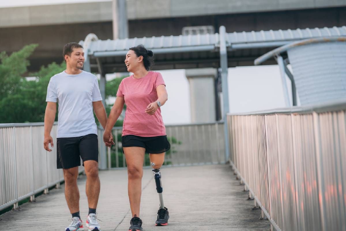 A woman with a prosthetic leg walks with a man near Edgewood, KY