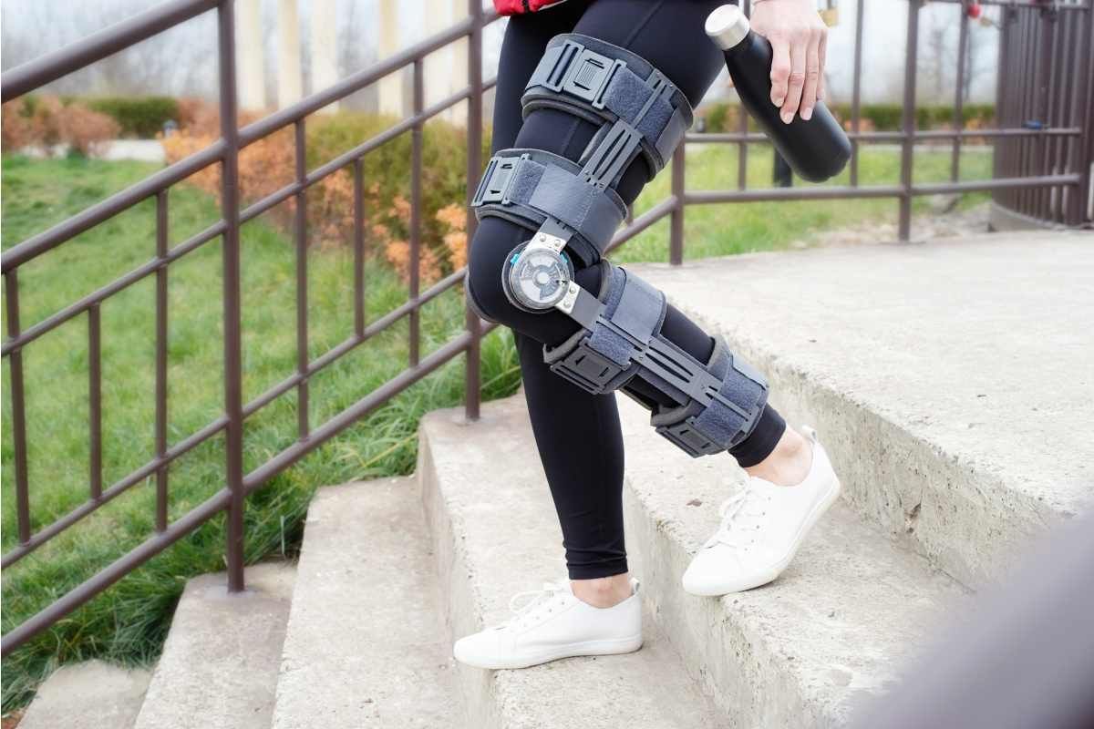 A person wearing an orthotic device on their knee while walking outdoors near Lawrenceburg, Indiana (IN)