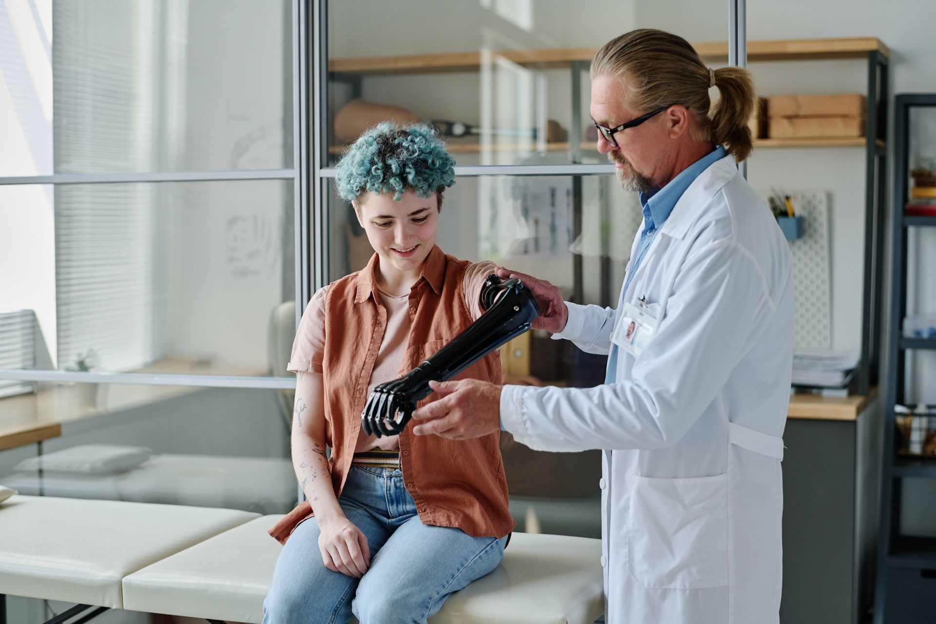 Prosthetic specialist assisting a patient with an arm fitting in an office near Edgewood, KY, and Lawrenceburg, IN