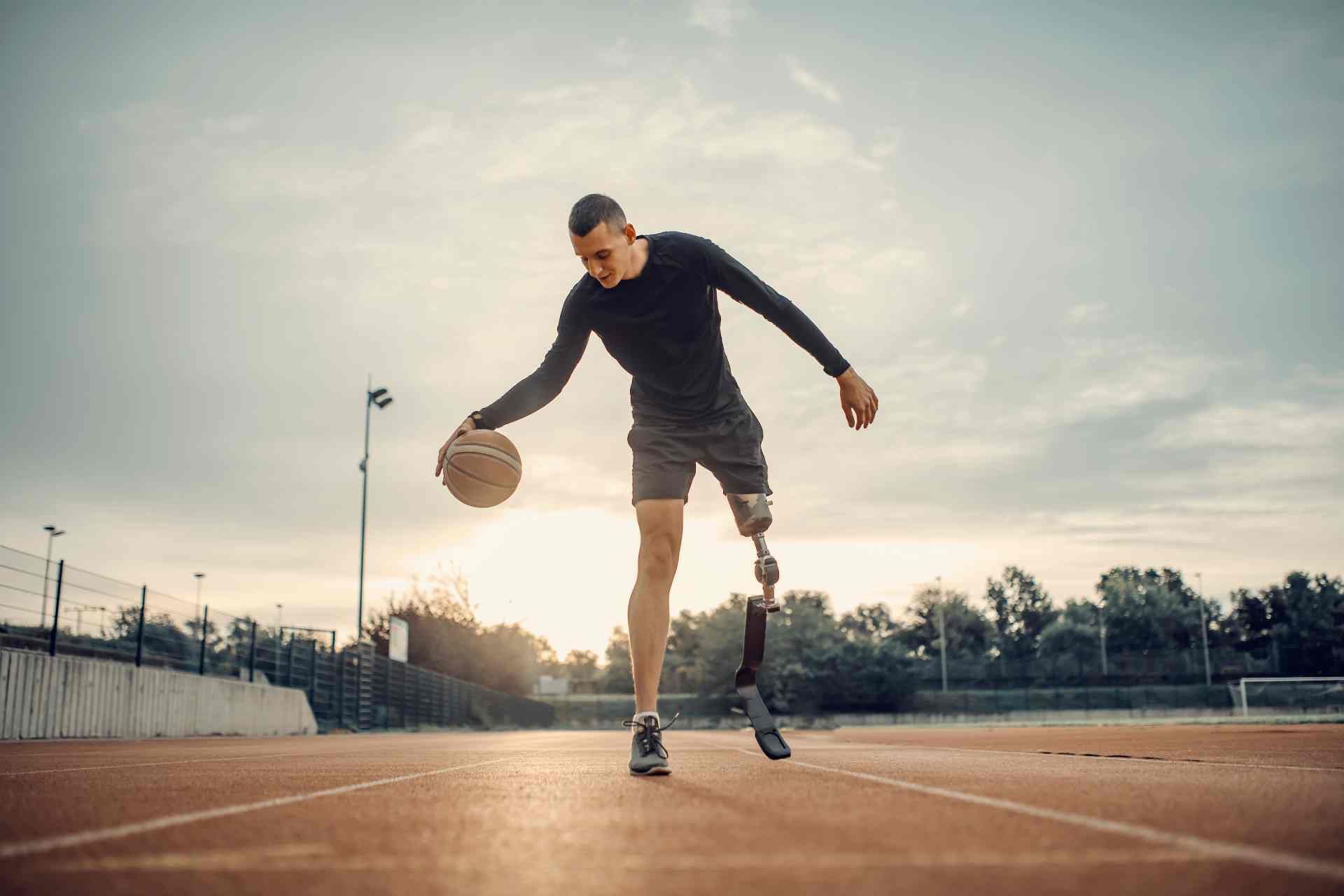 Man with prosthetic leg dribbling a basketball near Edgewood, KY, and Lawrenceburg, IN