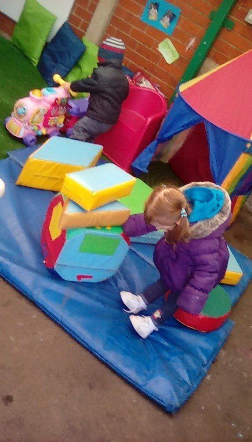 toddler in purple jacket playing outside