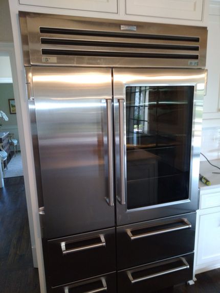 a stainless steel refrigerator with a glass door
