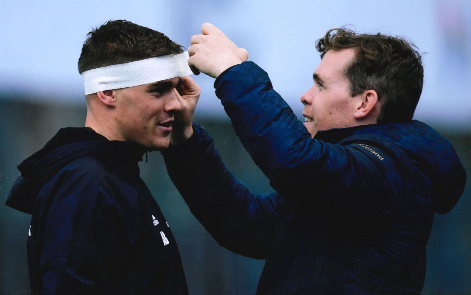 A couple of phones sitting next to each other on a white background.