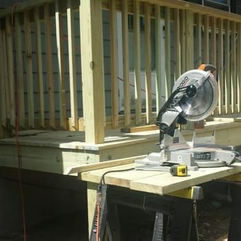 A circular saw is sitting on top of a wooden table.