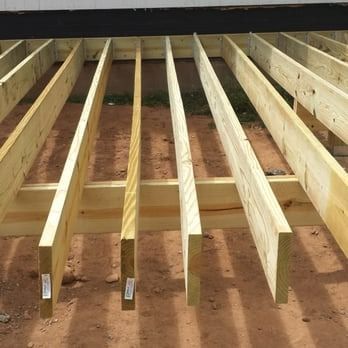 A row of wooden beams sitting on top of a dirt ground