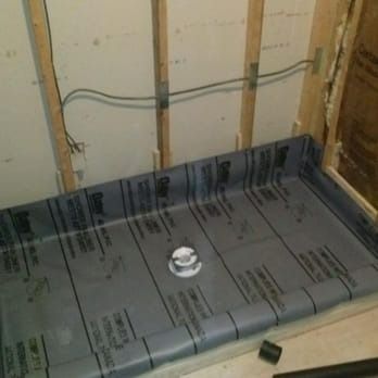 A shower stall is being built in a bathroom.