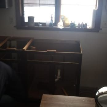 A kitchen with a sink and a window behind it