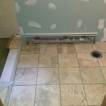A bathroom with tile floors and a toilet.