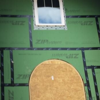 A green wall with zip system written on it