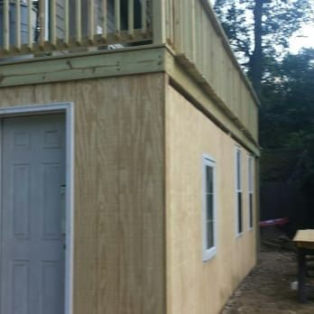 A wooden building with a balcony and a door
