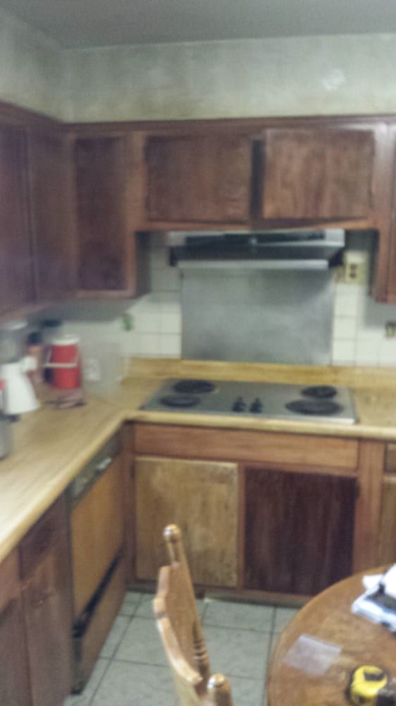 A kitchen with wooden cabinets and a stove top oven