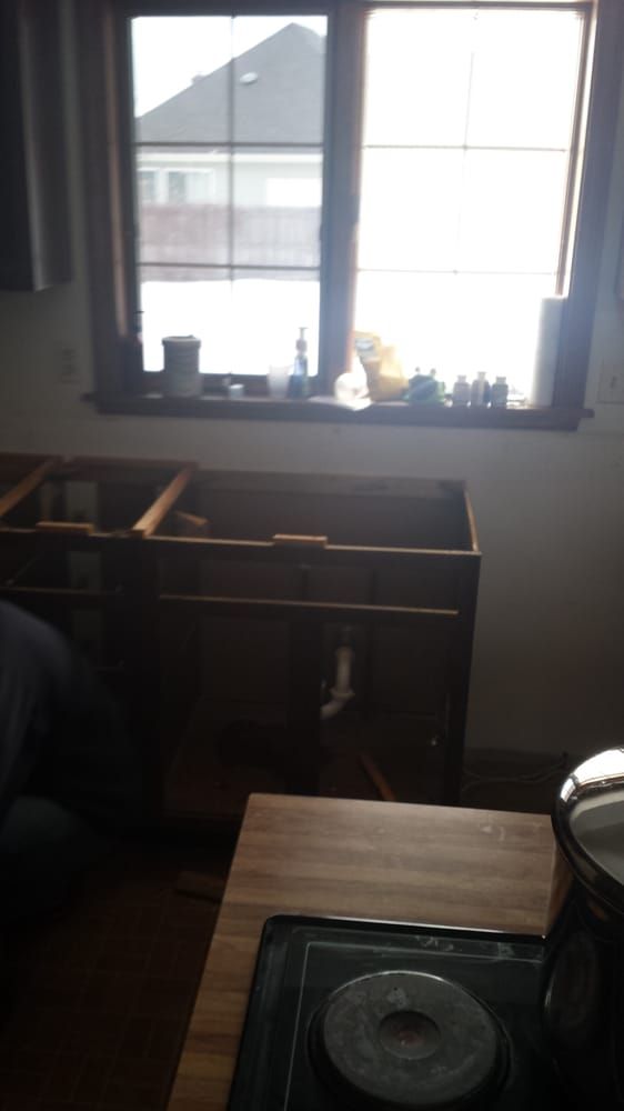 A kitchen with a stove top oven and a window