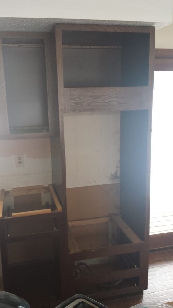 A room with a lot of cabinets and a window.