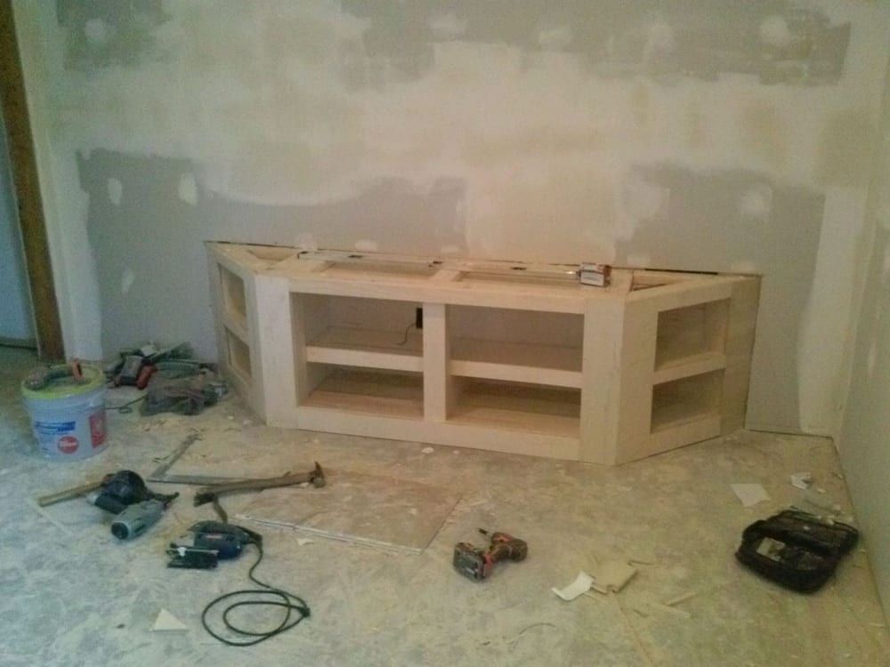 A room with two sinks and a drill on the floor