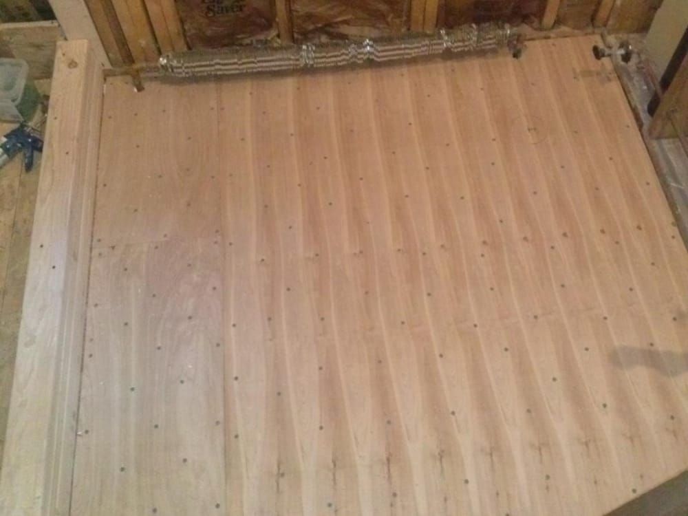 A wooden floor is being built in a room.
