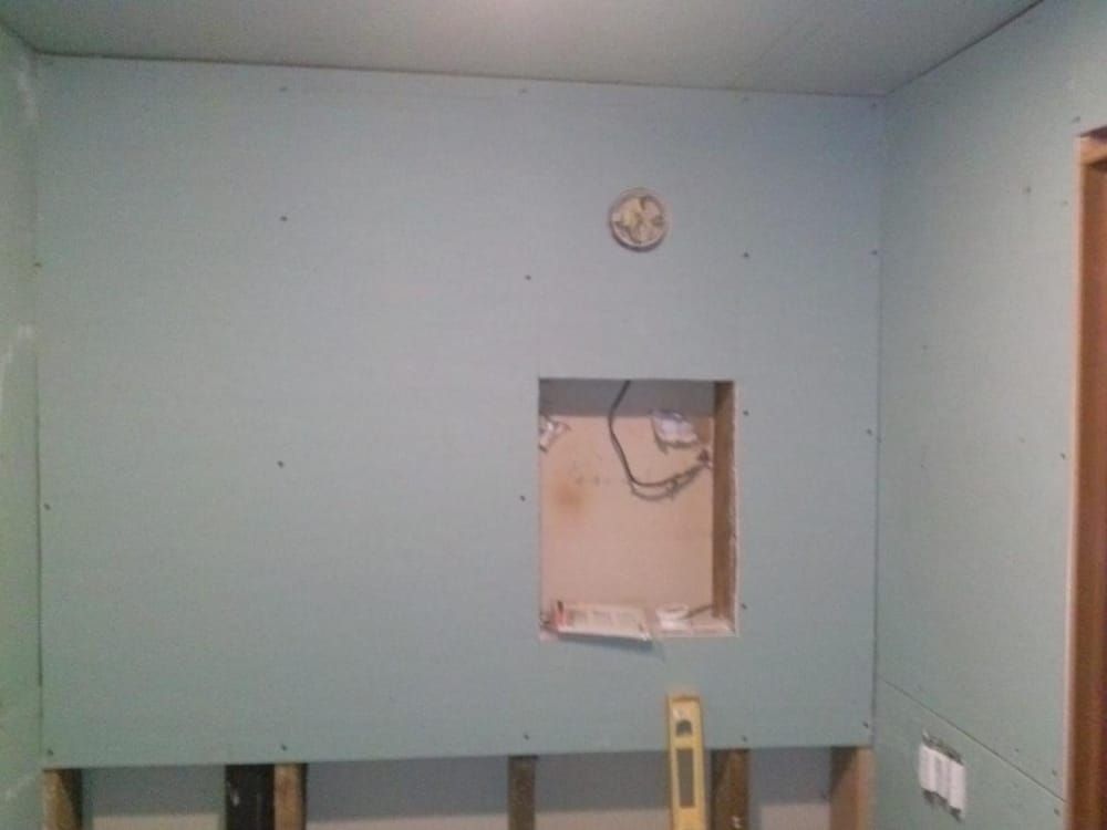 A room with a clock on the wall and a level on the wall.