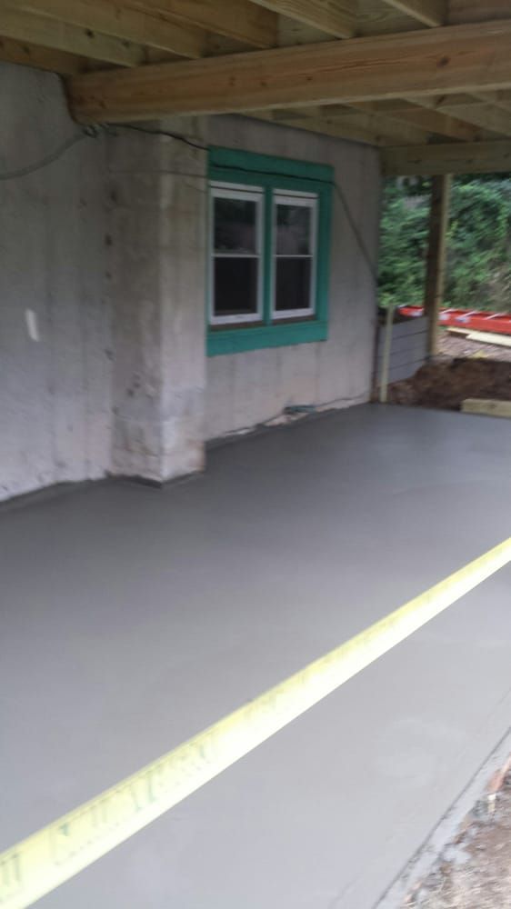 A room with a concrete floor and a window.