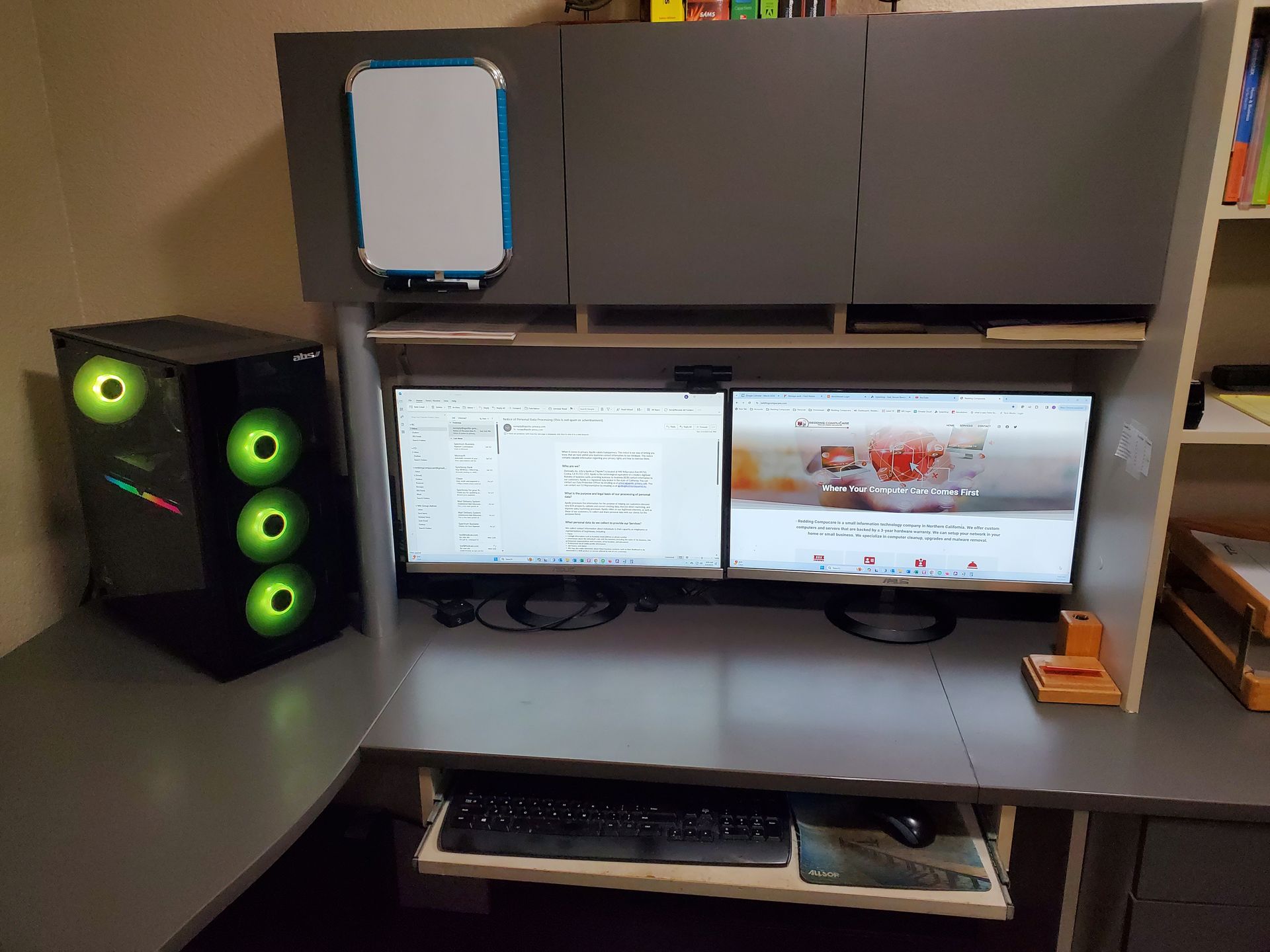 A computer desk with two monitors and a computer case.