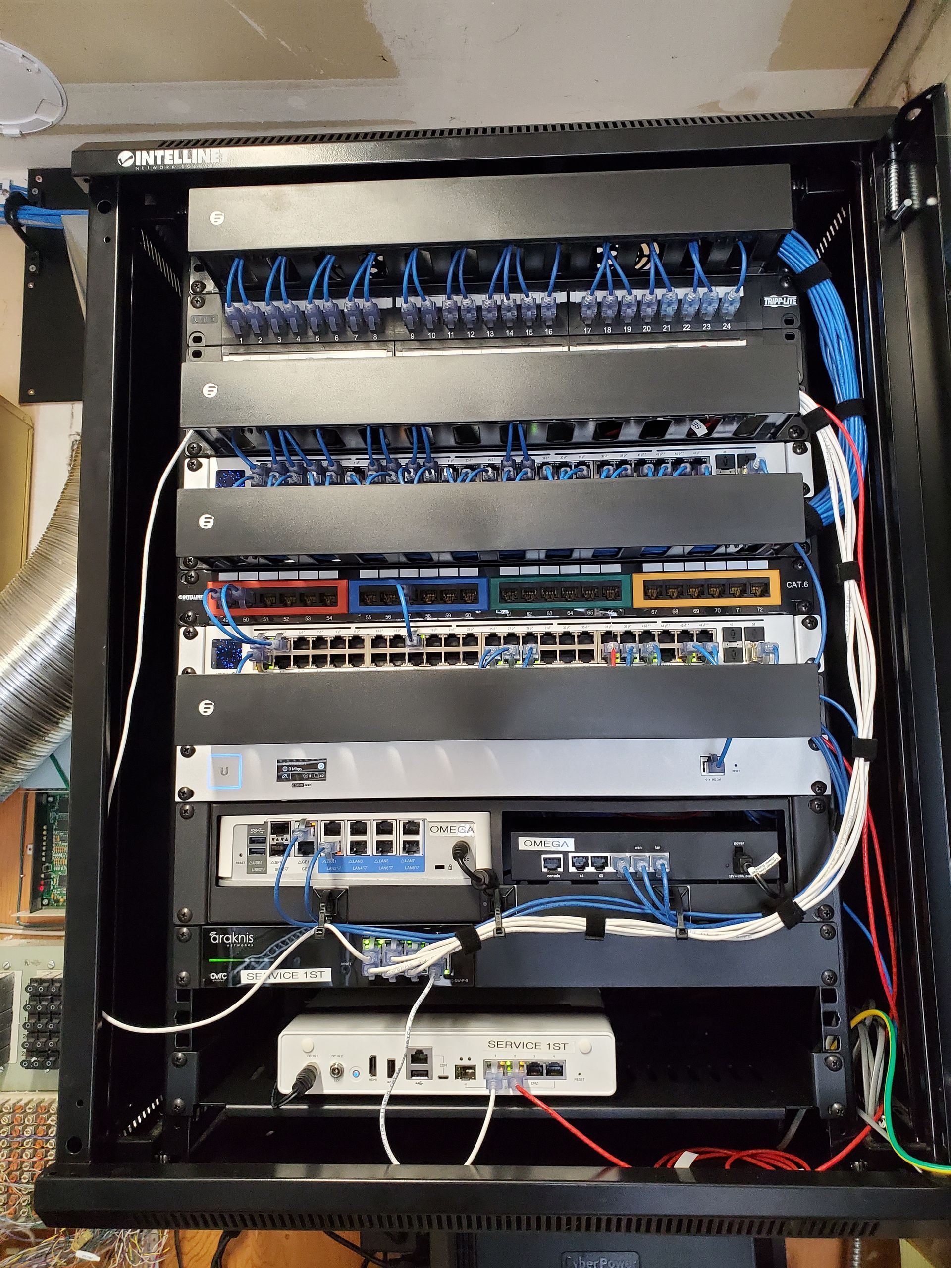 A server rack with a lot of wires coming out of it