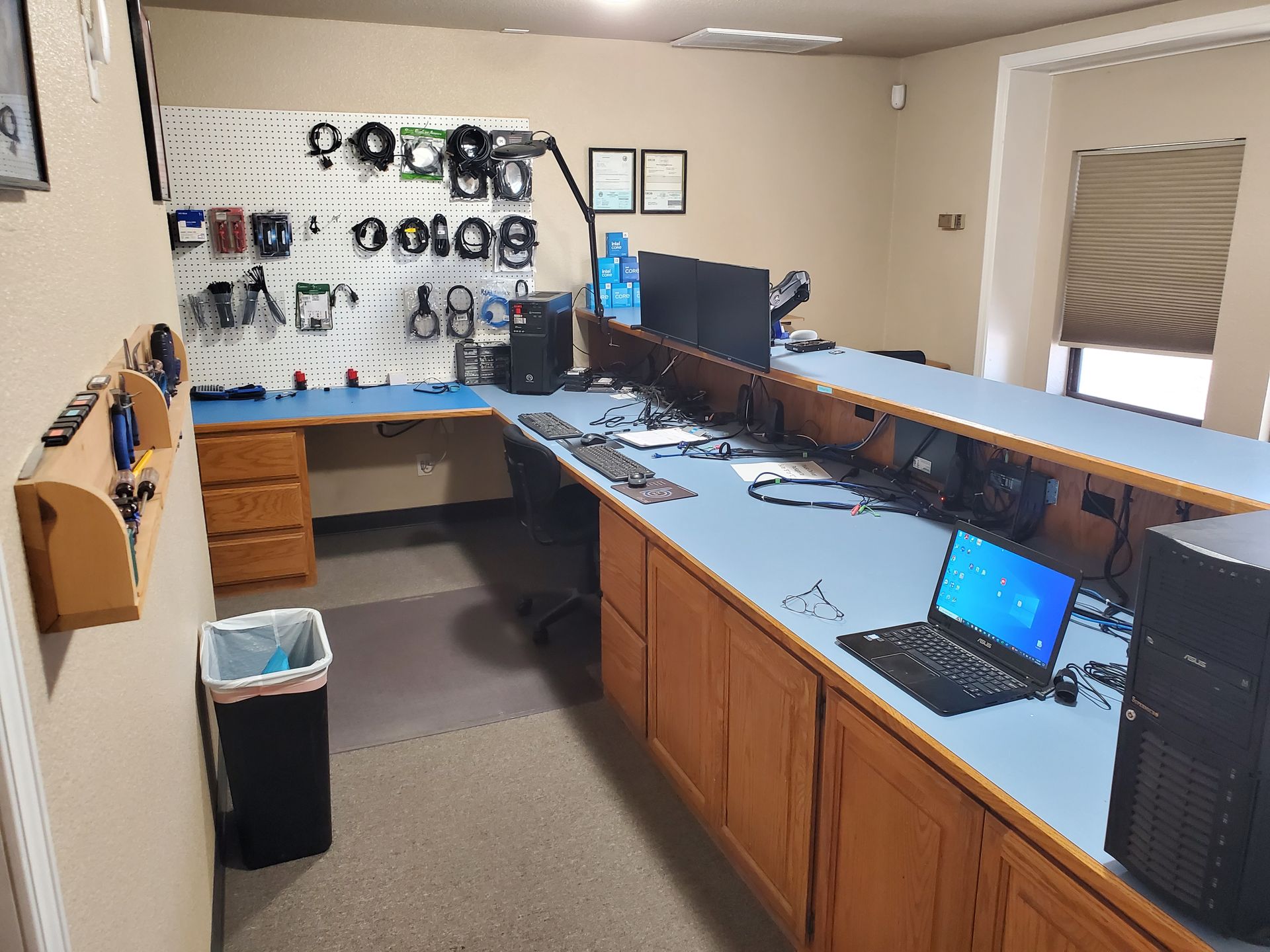 A computer repair shop with a laptop on the counter