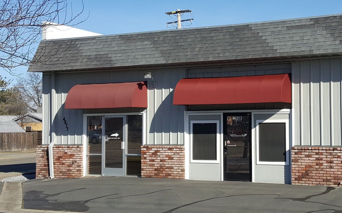 A building with a red awning on the front of it