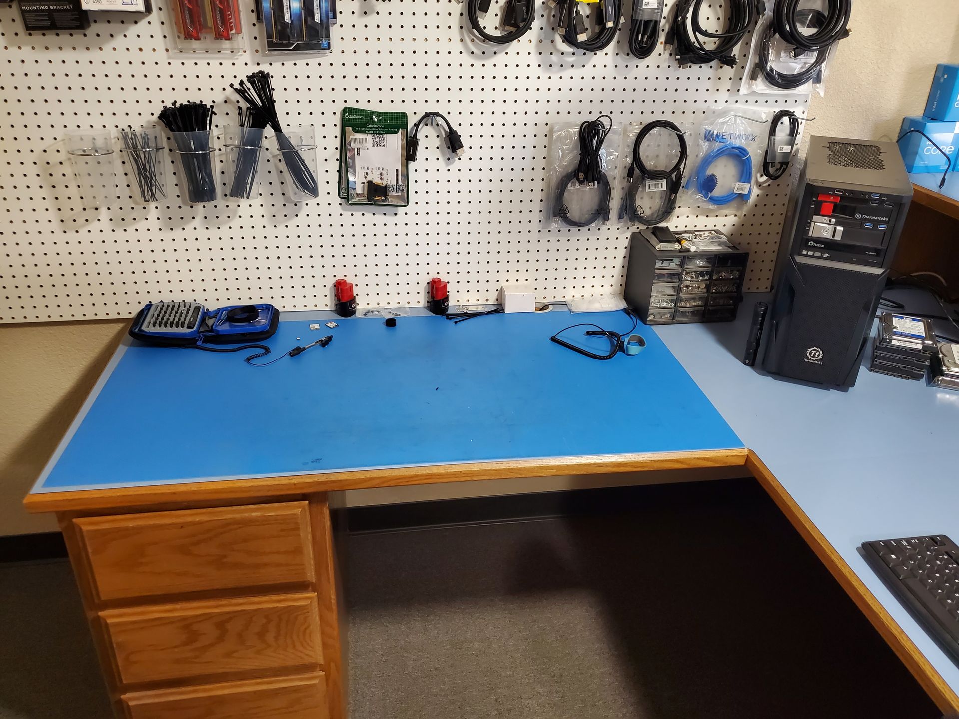 A blue workbench with a computer on it