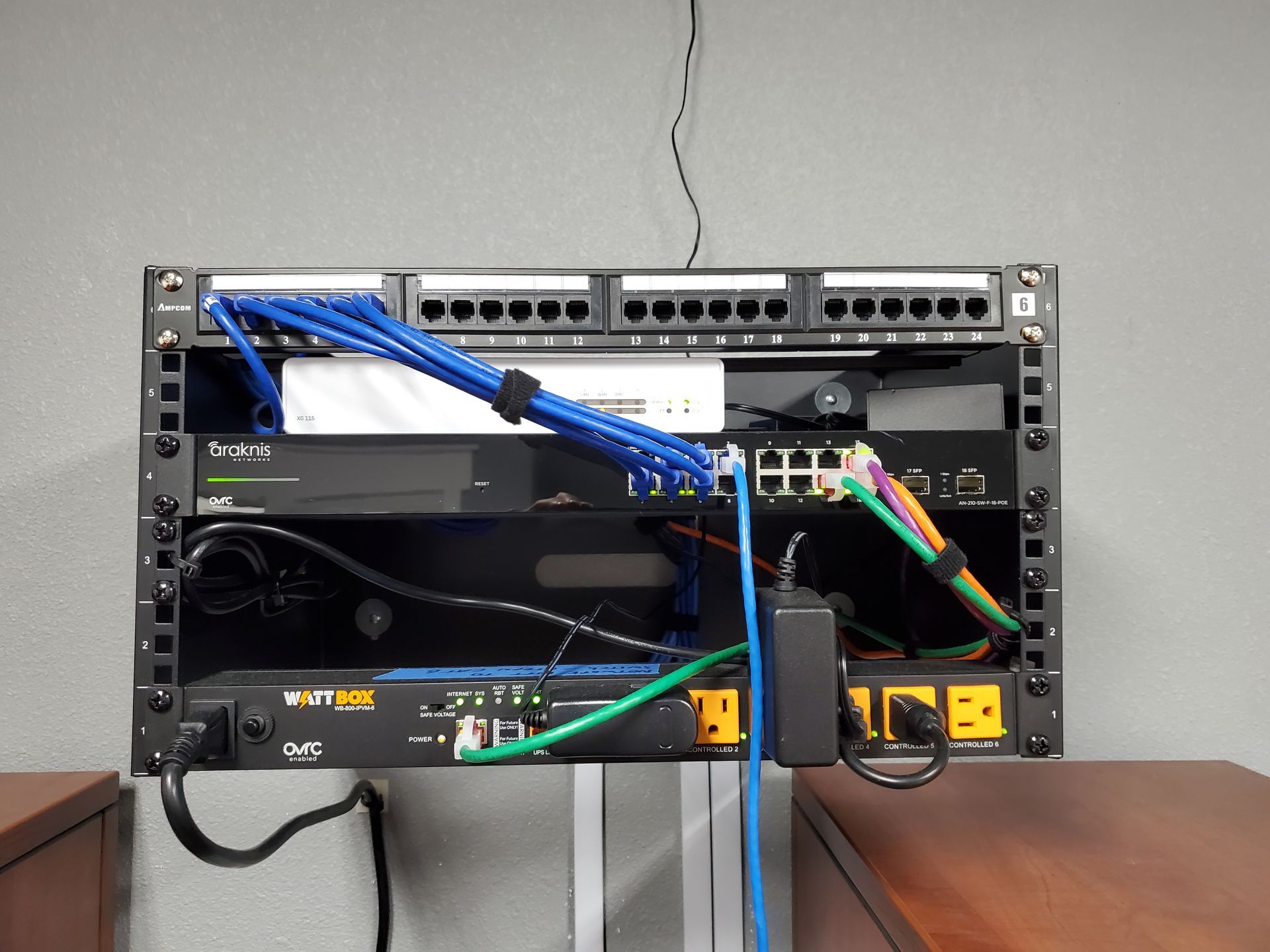 A rack with a lot of wires coming out of it and the letter b on it