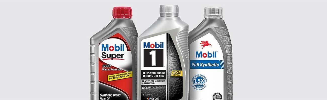 Three bottles of Mobil motor oil. The bottles are silver with various labels.